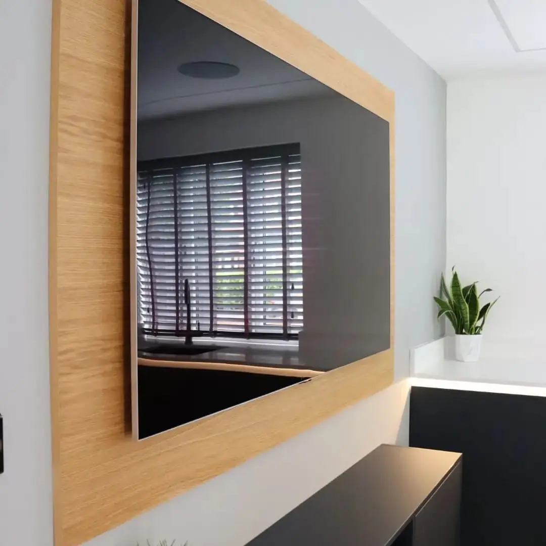 Oak-framed TV feature wall reflecting the kitchen window