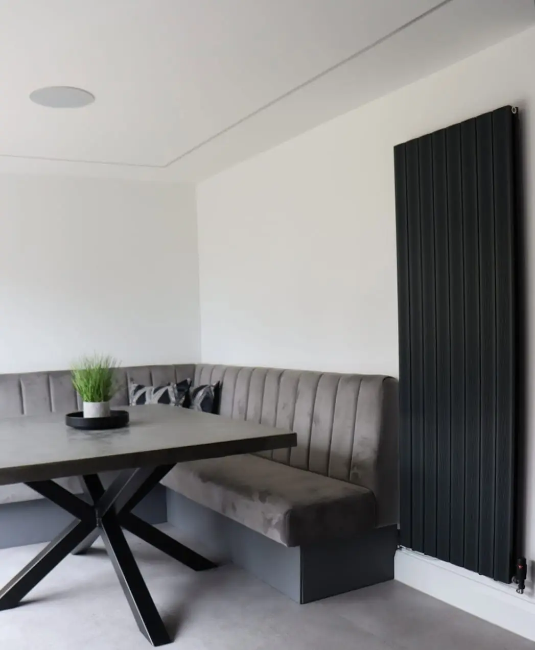 Corner banquette dining seating with black X-frame table